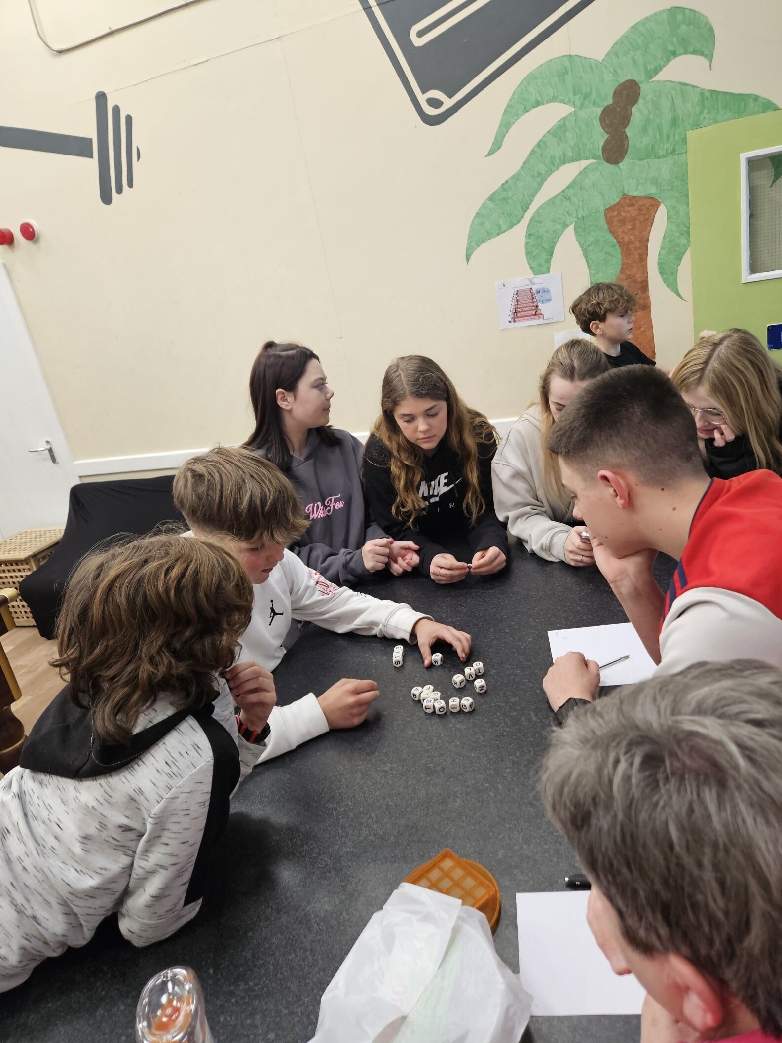 Children gathered round a table in the Youth Club for a group activity.
