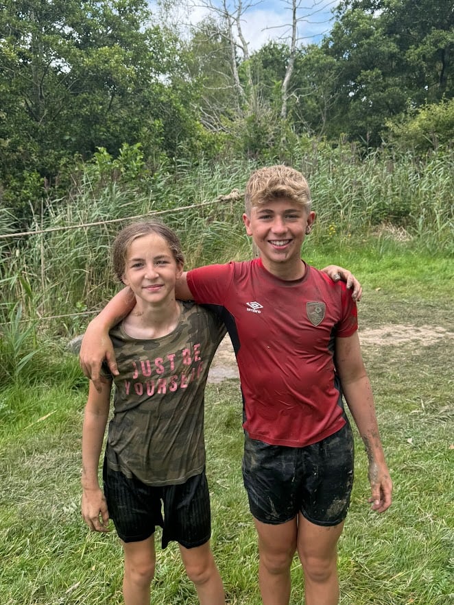 Two young people after completing an assault course.